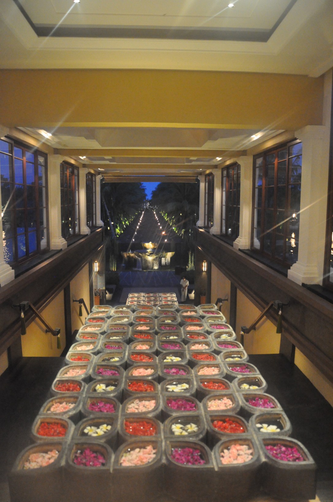 Lobby and walk to the beach lit up at night. 